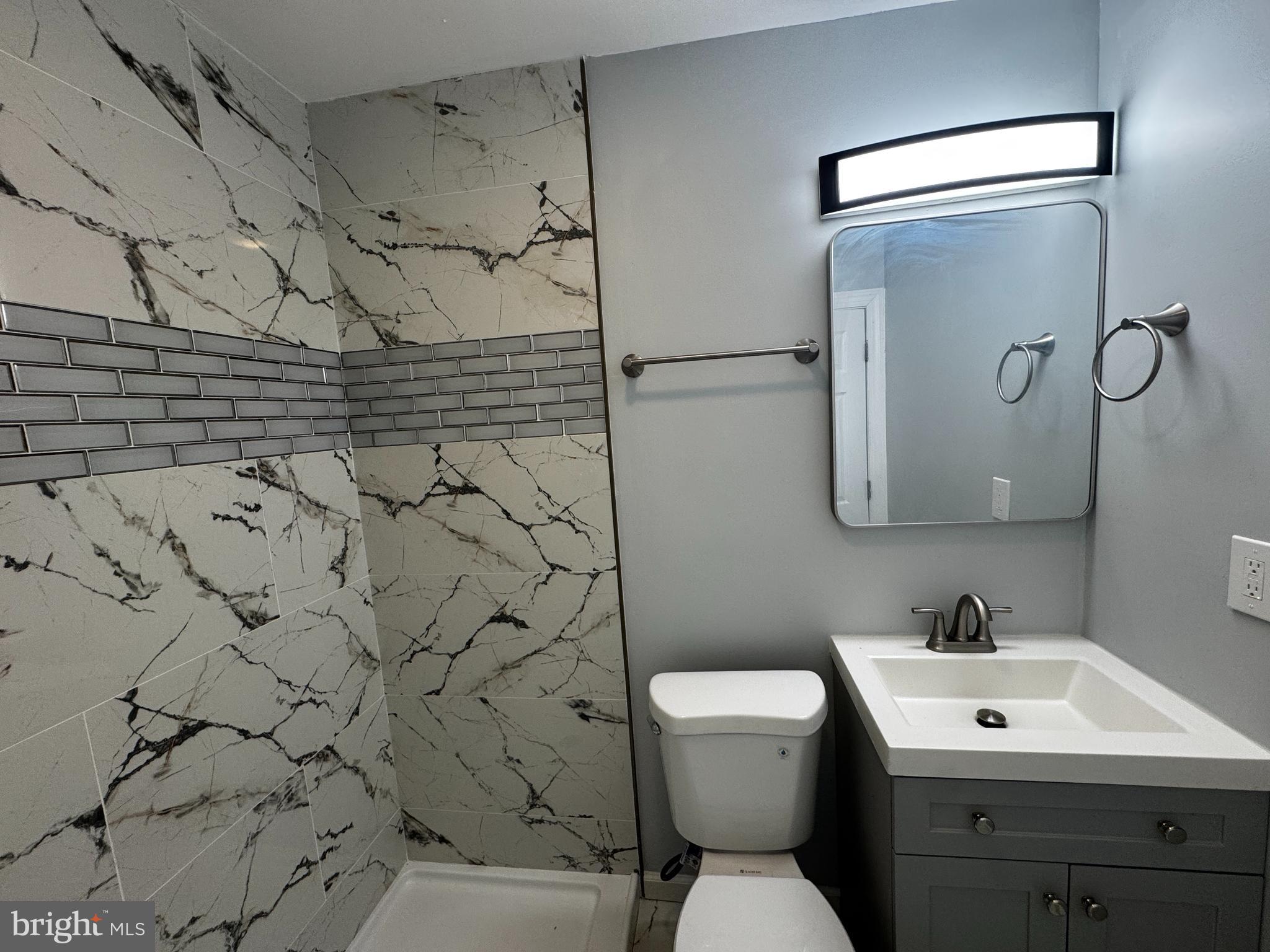 2427 Grubb Road Wilmington, DE 19810 - Photo 5 of 32 a bathroom with a toilet sink and mirror