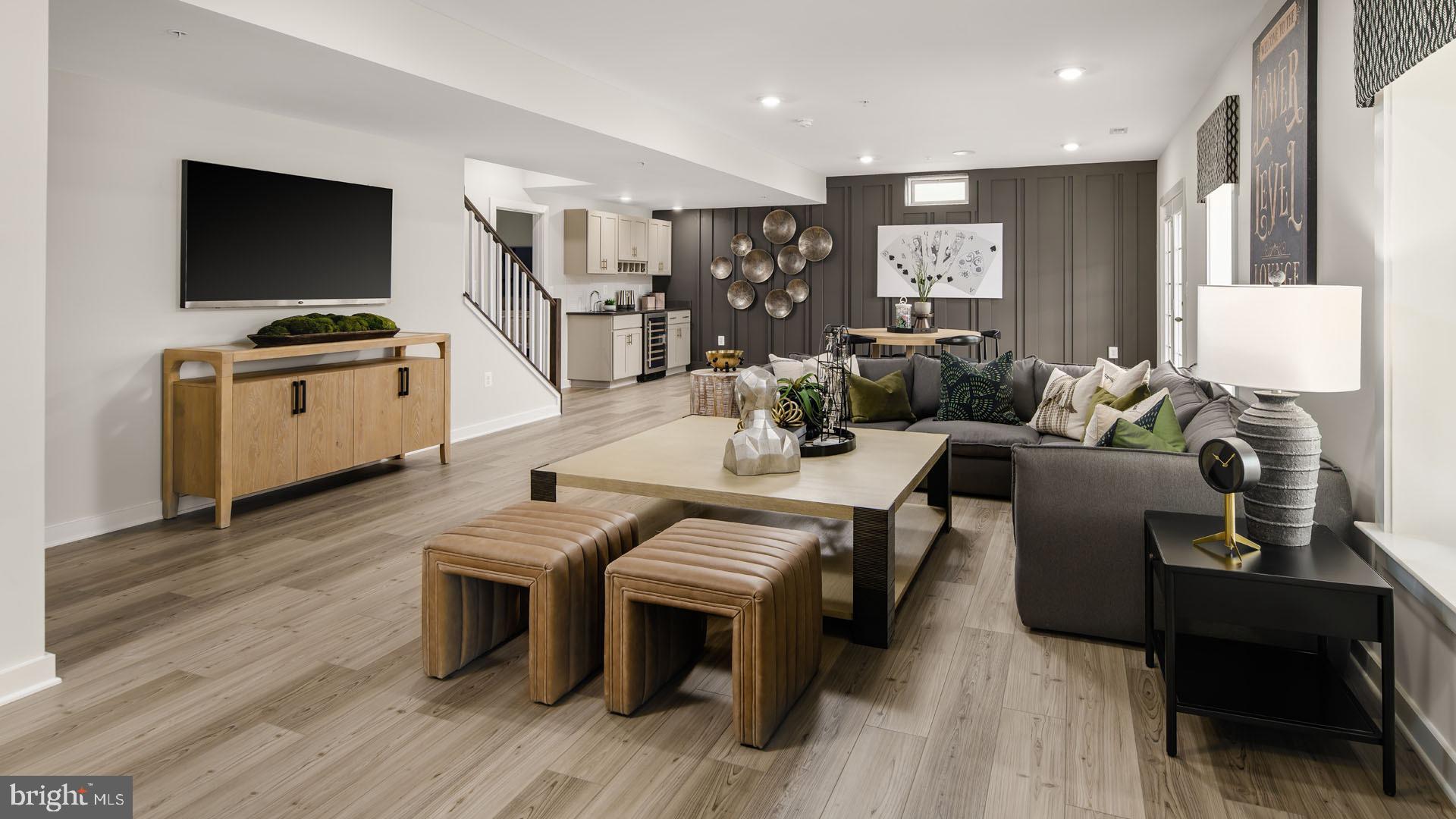Tbb Tbb Brandenburg Farm, Unit ALBEMARLE Brunswick, MD 21716 - Photo 18 of 52 a living room with furniture a flat screen tv and kitchen view