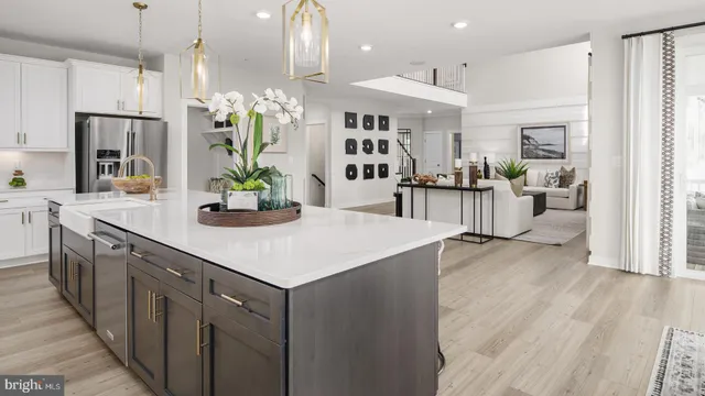 a kitchen with a sink a counter top space and stainless steel appliances