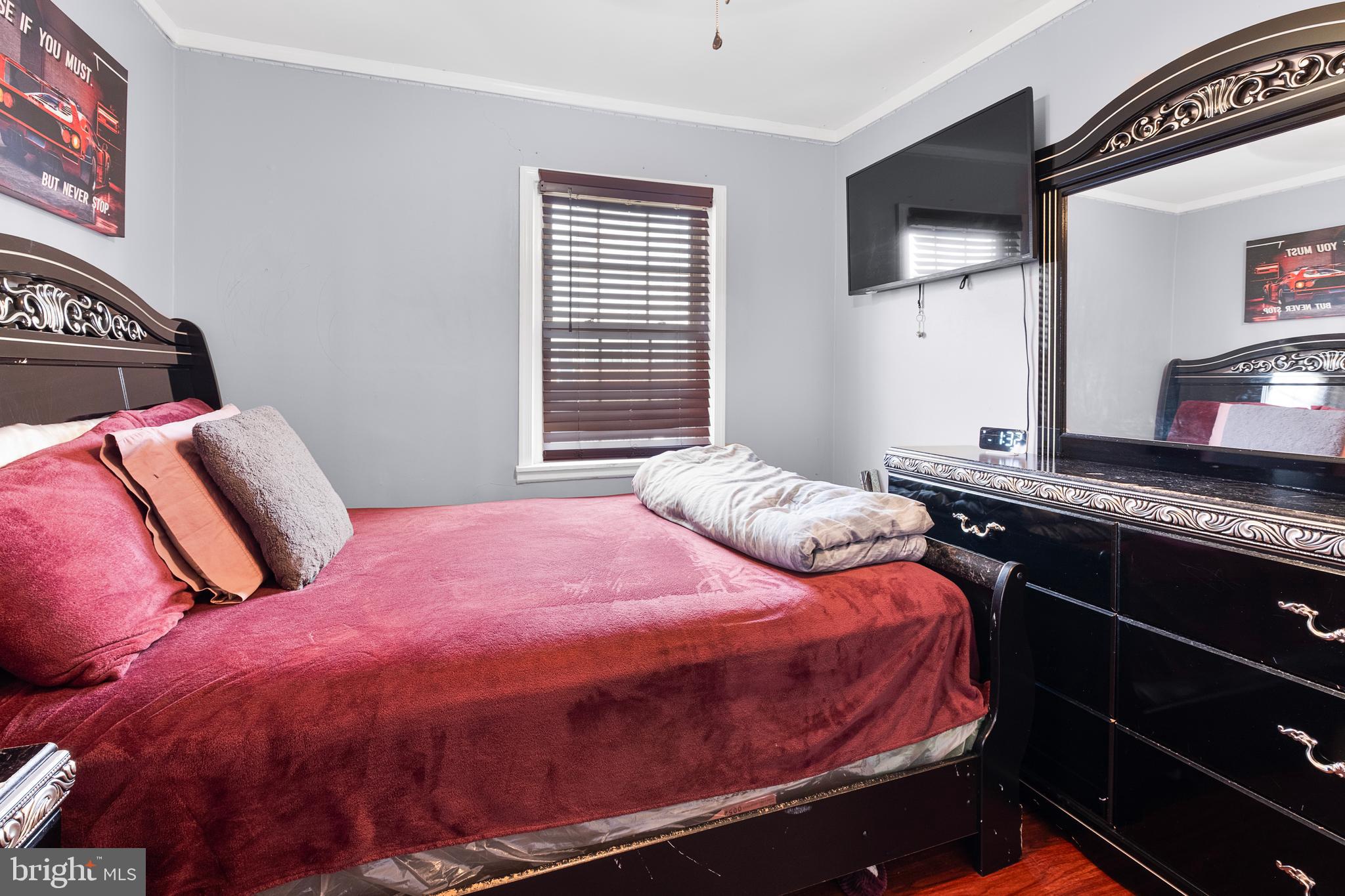 2208 Virginia Avenue Landover, MD 20785 - Photo 16 of 17 a bedroom with a bed and wooden floor
