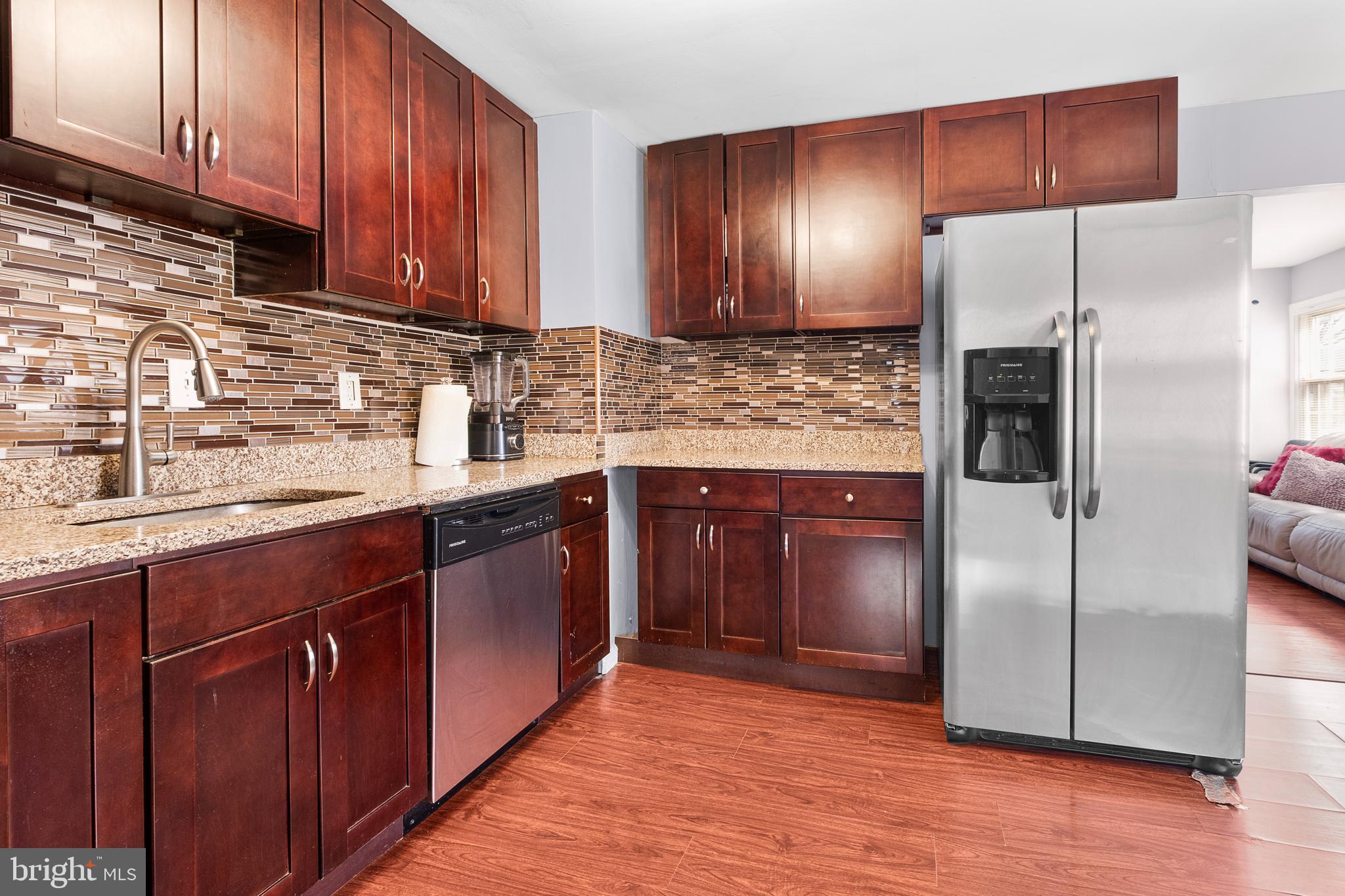 2208 Virginia Avenue Landover, MD 20785 - Photo 8 of 17 a kitchen with stainless steel appliances granite countertop wooden cabinets a refrigerator and a sink