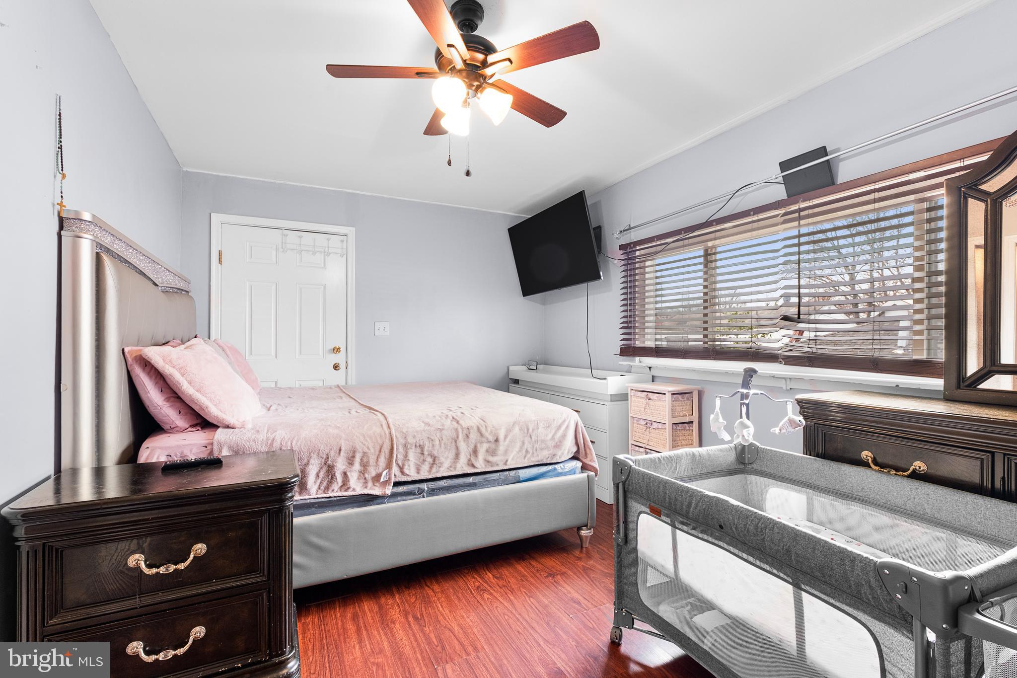 2208 Virginia Avenue Landover, MD 20785 - Photo 9 of 17 a bedroom with a bed window and a flat screen tv