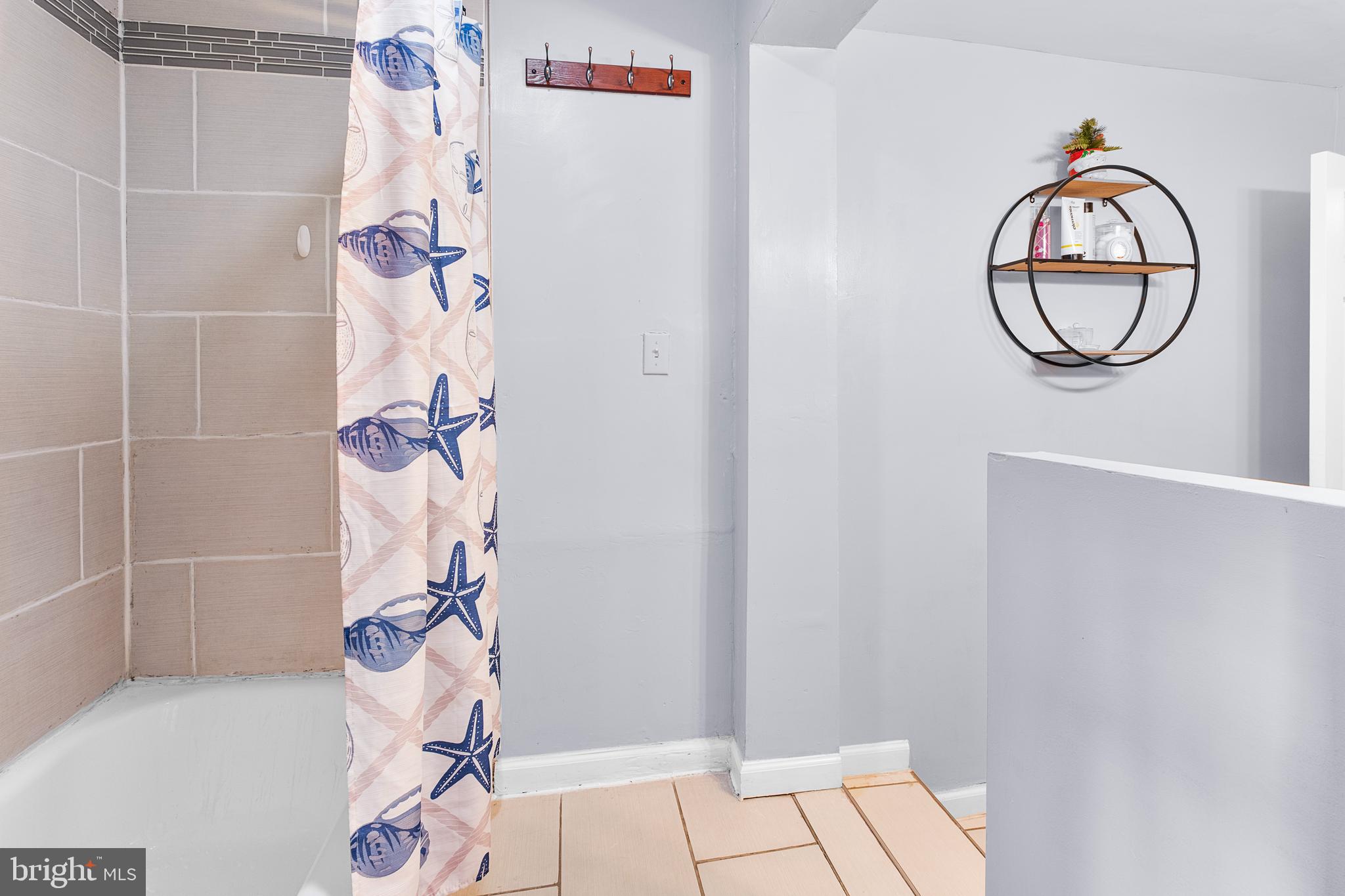 2208 Virginia Avenue Landover, MD 20785 - Photo 10 of 17 a bathroom with a glass shower door and a mirror