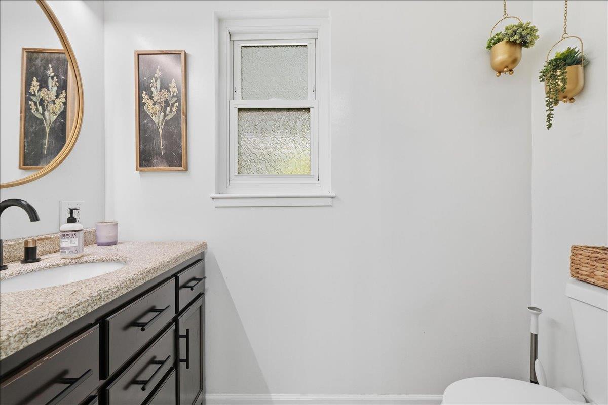 4849 Alexon Way Carmichael, CA 95608 - Photo 21 of 50 a bathroom with a granite countertop toilet sink and mirror
