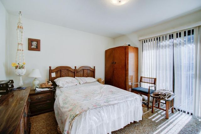 a bedroom with bed and a closet