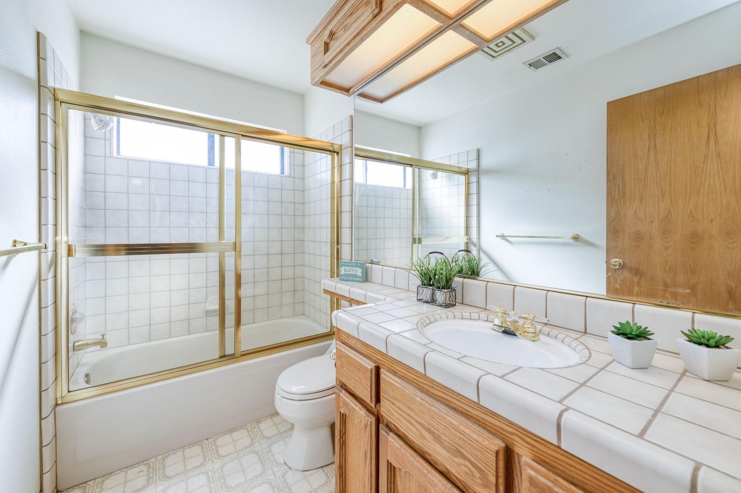 19650 Road 31 Madera, CA 93638 - Photo 17 of 43 a bathroom with a granite countertop sink toilet and shower