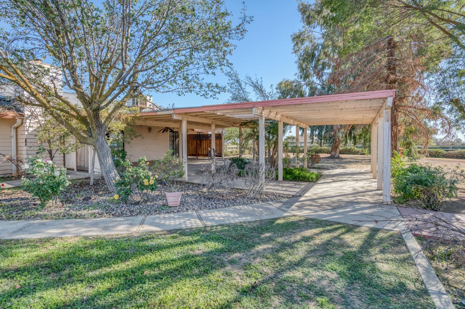 19650 Road 31 Madera, CA 93638 - Photo 38 of 43 a view of a house with a yard and potted plants