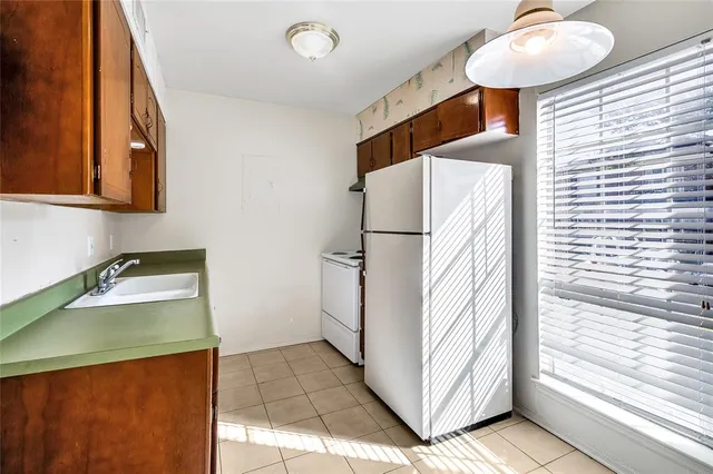 a kitchen with a refrigerator and a sink