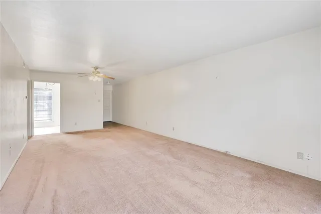 an empty room with a empty space and windows