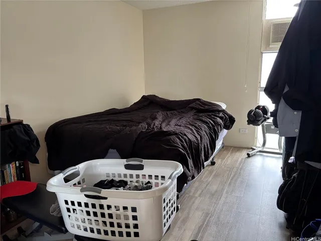 a bed sitting in a bedroom next to a window