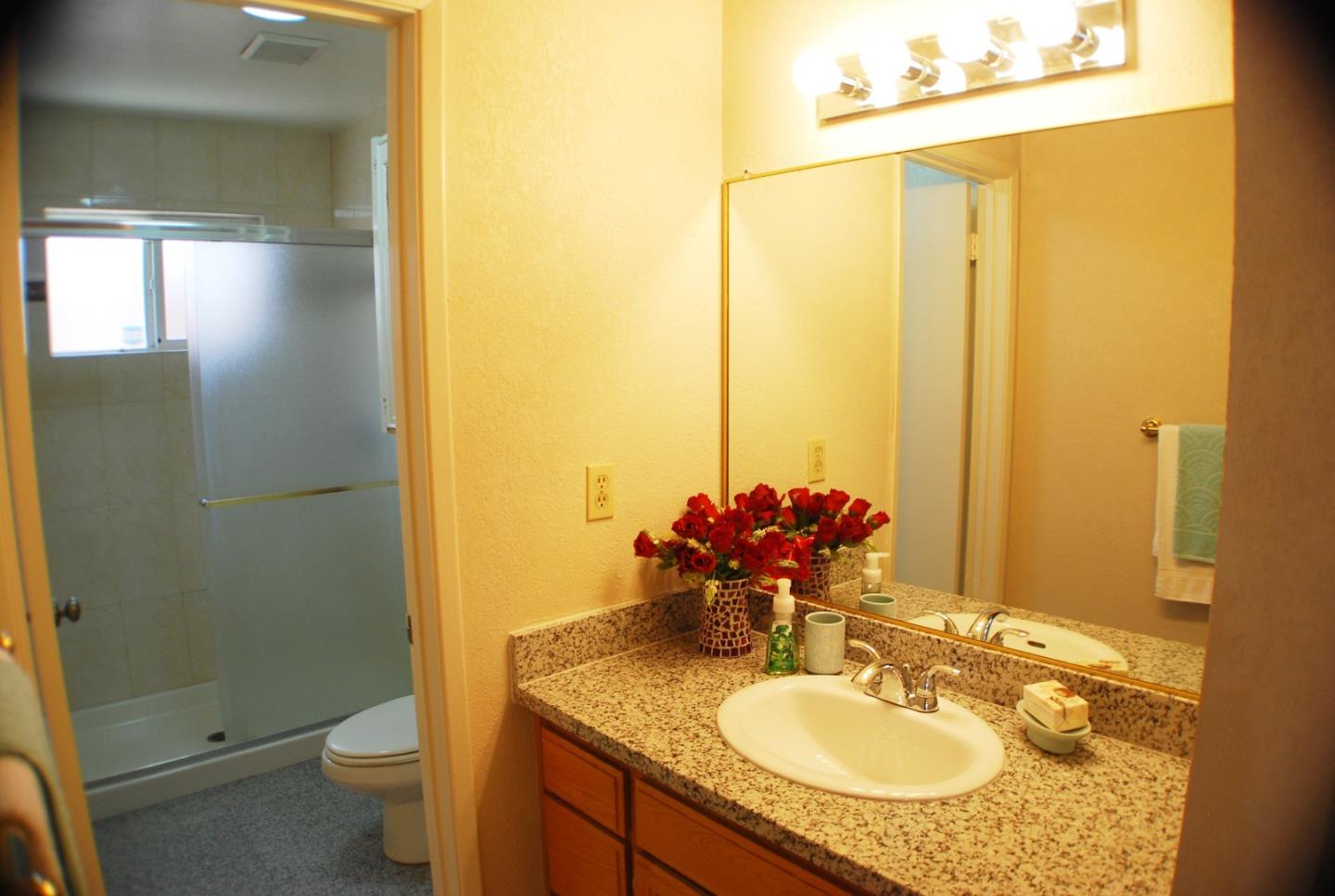 3381 Tully Road San Jose, CA 95148 - Photo 12 of 17 a bathroom with a granite countertop sink toilet and shower