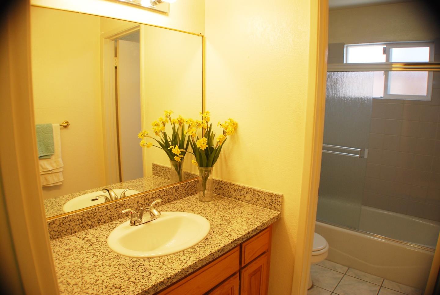 3381 Tully Road San Jose, CA 95148 - Photo 10 of 17 a bathroom with a granite countertop sink and a mirror