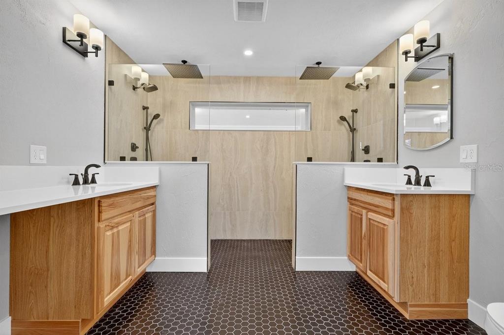 720 Pringle Road Port Orange, FL 32127 - Photo 14 of 68 a bathroom with a double vanity sink a and a shower