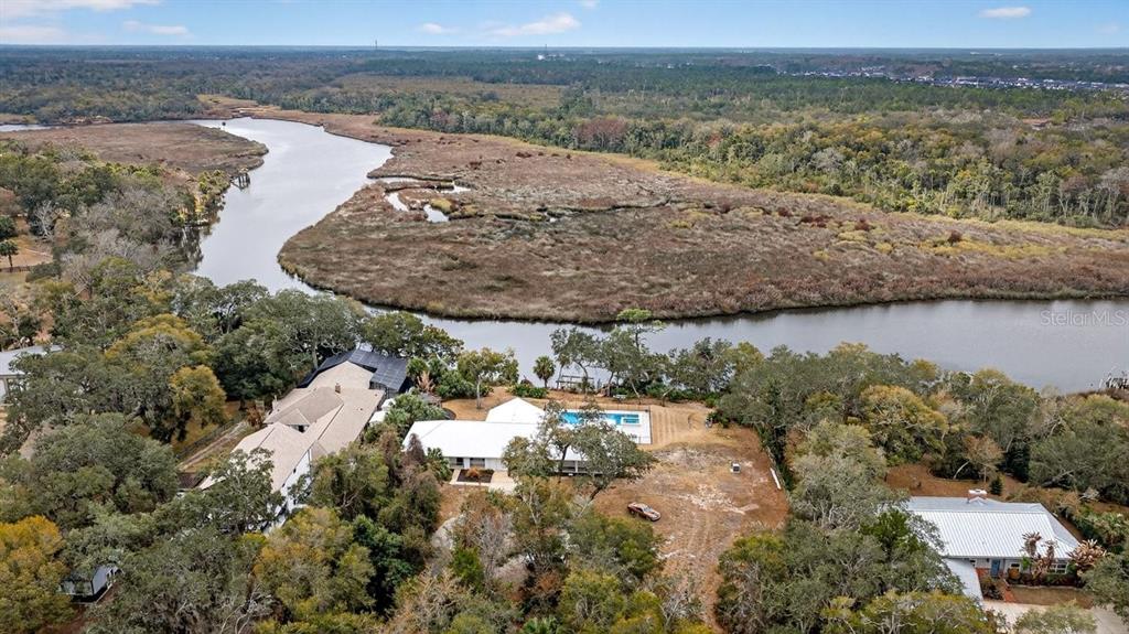 720 Pringle Road Port Orange, FL 32127 - Photo 24 of 68 a view of a lake with a mountain and trees in the back