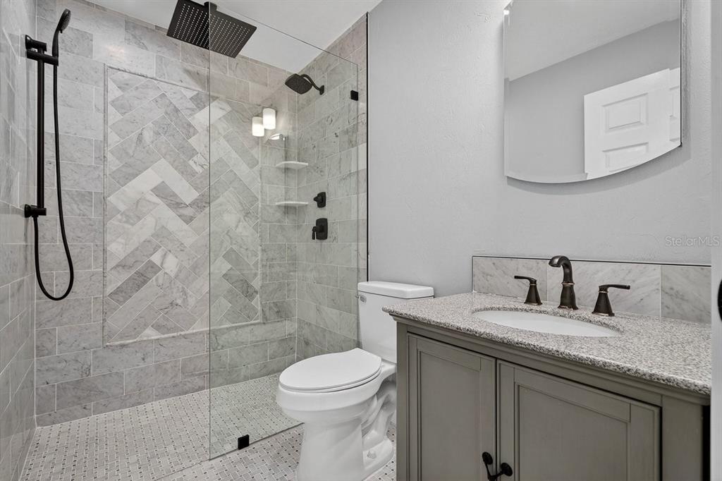 720 Pringle Road Port Orange, FL 32127 - Photo 38 of 68 a bathroom with a granite countertop sink a toilet and shower