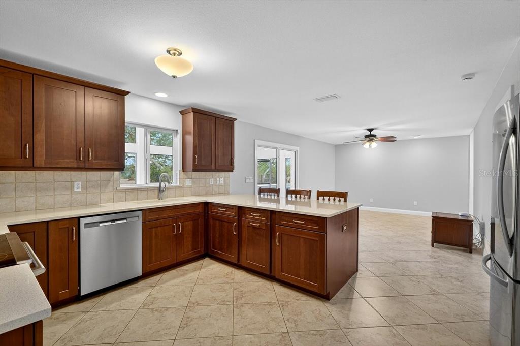 720 Pringle Road Port Orange, FL 32127 - Photo 46 of 68 a kitchen with stainless steel appliances granite countertop a sink and cabinets