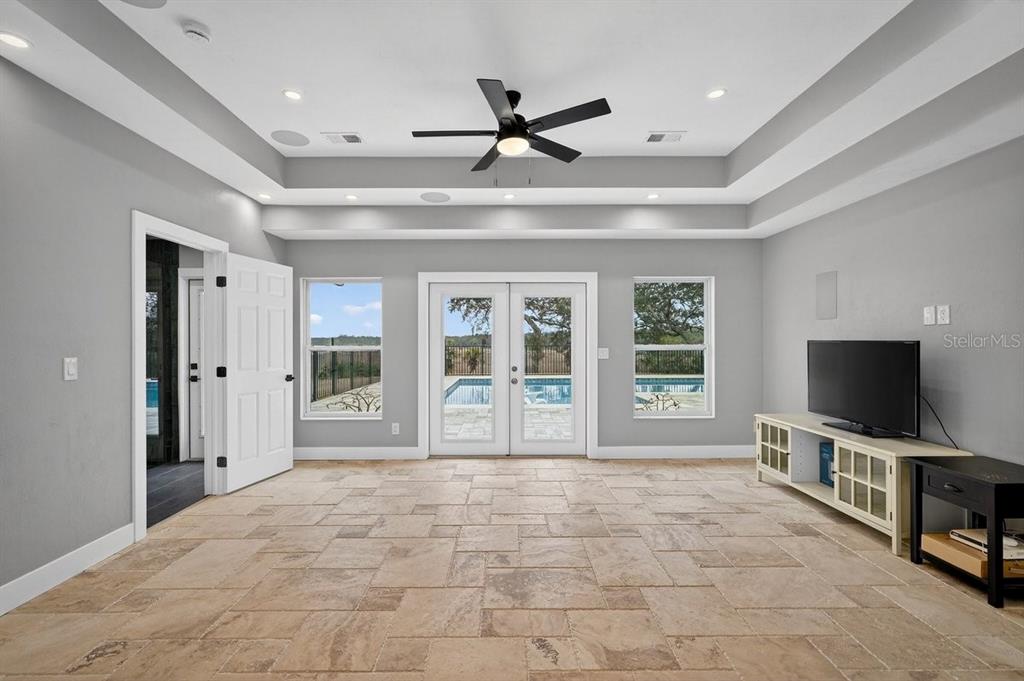 720 Pringle Road Port Orange, FL 32127 - Photo 6 of 68 a view of livingroom with flat screen tv cabinets and ceiling fan