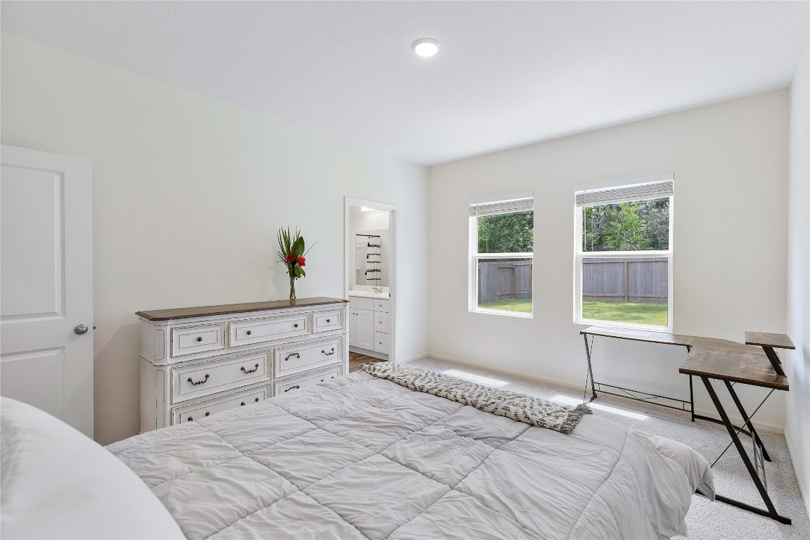 3626 Addington Ct. Huffman, TX 77336 - Photo 14 of 26 a bedroom with a bed and a window with chair
