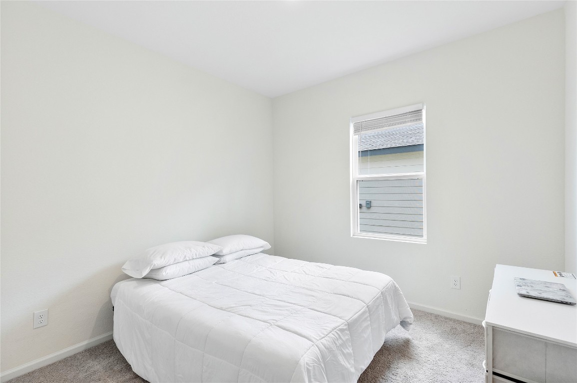 3626 Addington Ct. Huffman, TX 77336 - Photo 20 of 26 a bedroom with a bed and a window
