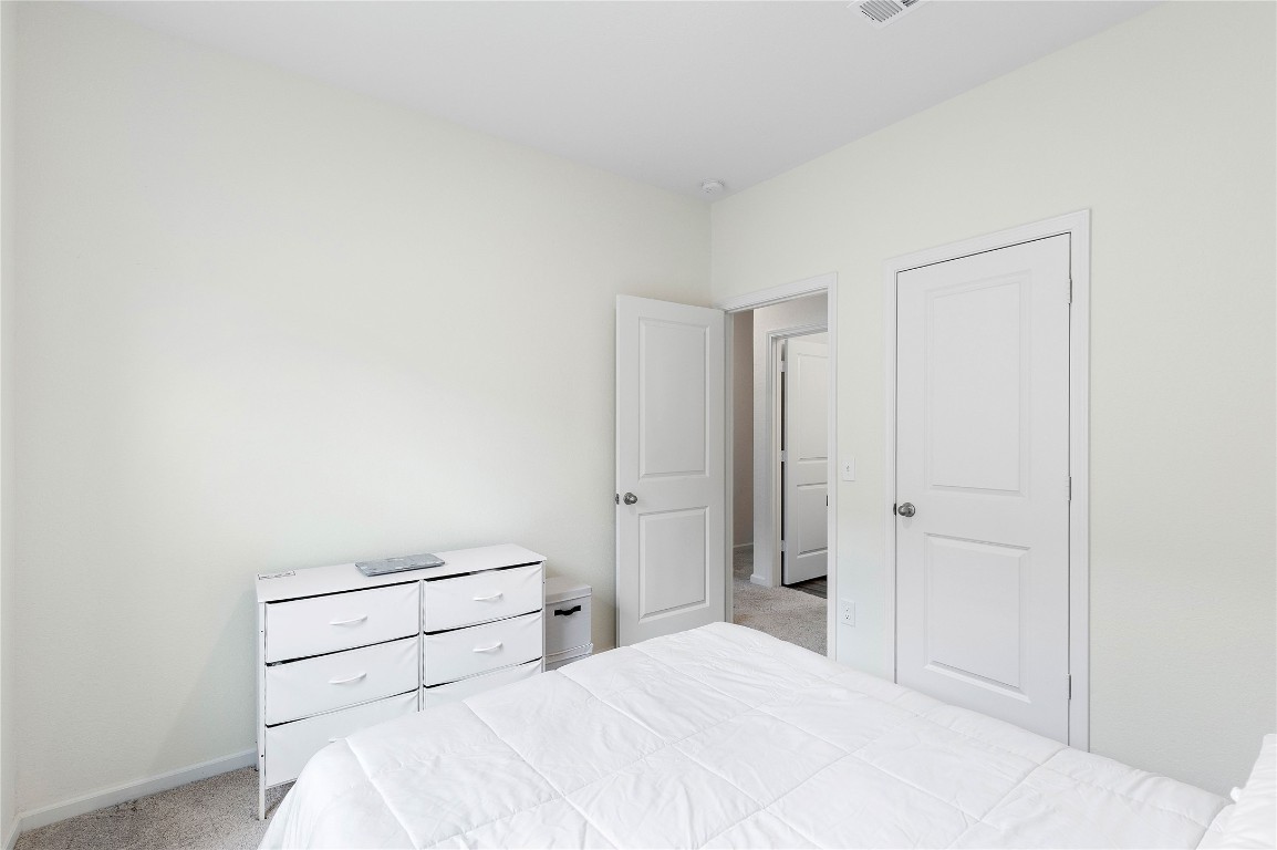 3626 Addington Ct. Huffman, TX 77336 - Photo 21 of 26 a bedroom with a bed and a closet