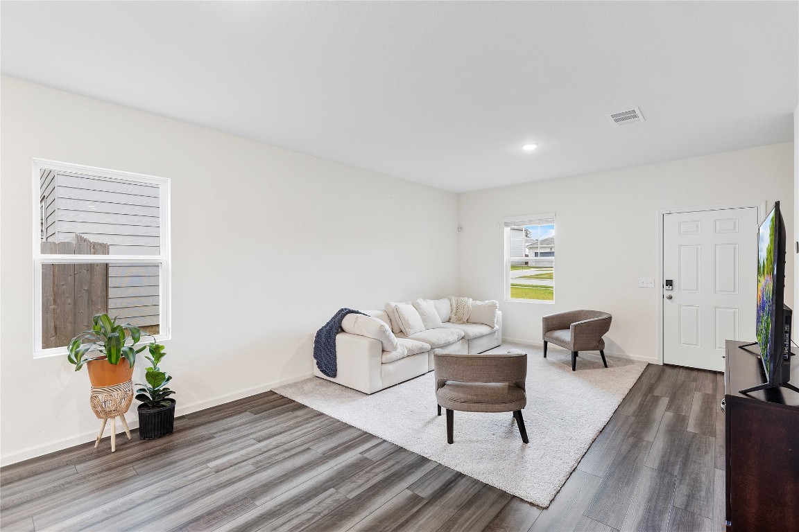 3626 Addington Ct. Huffman, TX 77336 - Photo 8 of 26 a living room with furniture a wooden floor and a potted plant