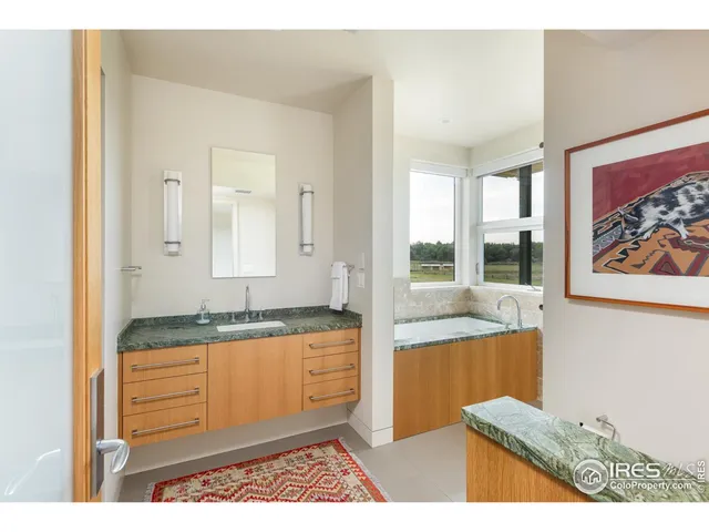 a kitchen with granite countertop sink and cabinets