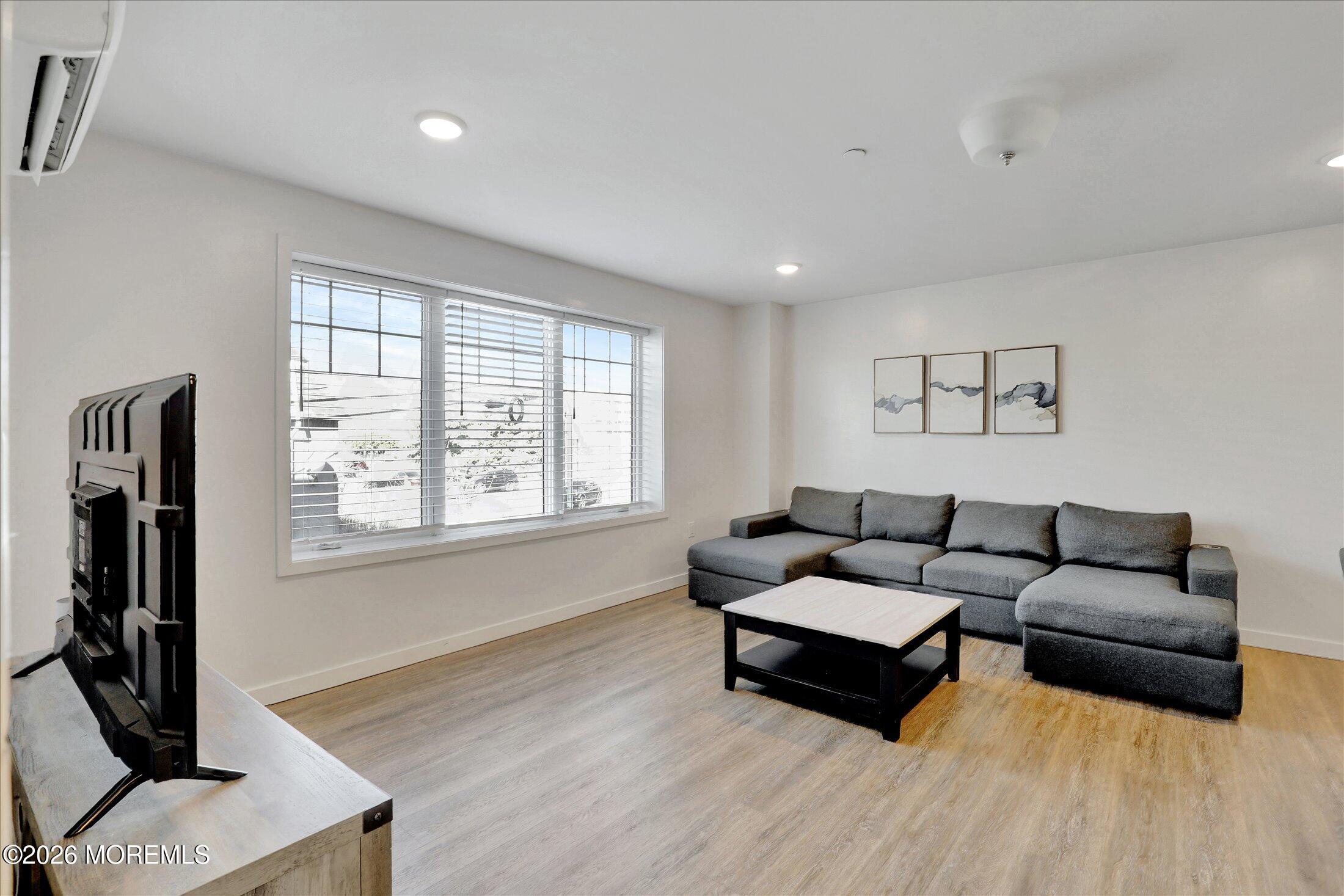 55 Brighton Avenue, Unit 4 Long Branch, NJ 07740 - Photo 16 of 36 a living room with furniture and a flat screen tv
