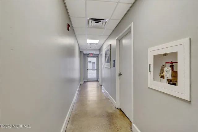 a view of a hallway view with wooden floor and staircase
