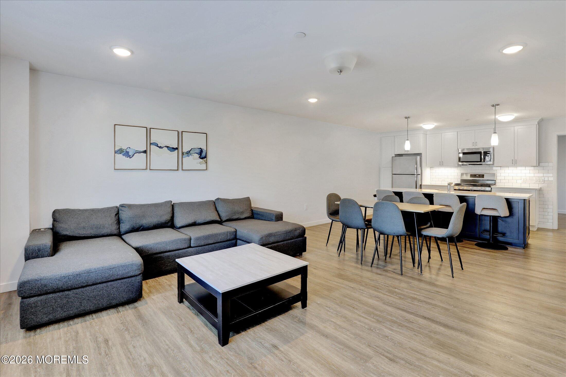 55 Brighton Avenue, Unit 4 Long Branch, NJ 07740 - Photo 18 of 36 a living room with furniture and a wooden floor