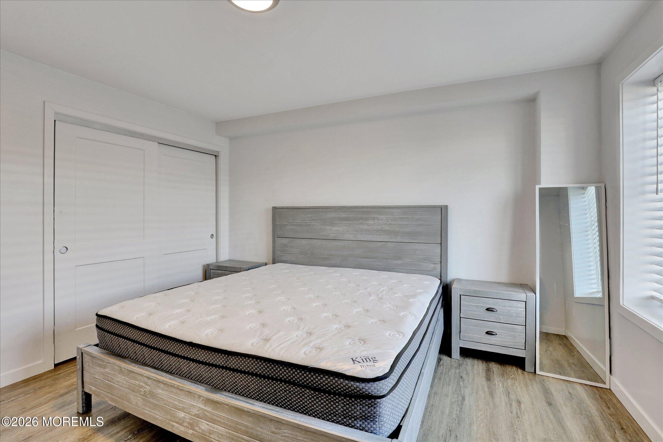 55 Brighton Avenue, Unit 4 Long Branch, NJ 07740 - Photo 21 of 36 a bedroom with a bed and a tv on the dresser