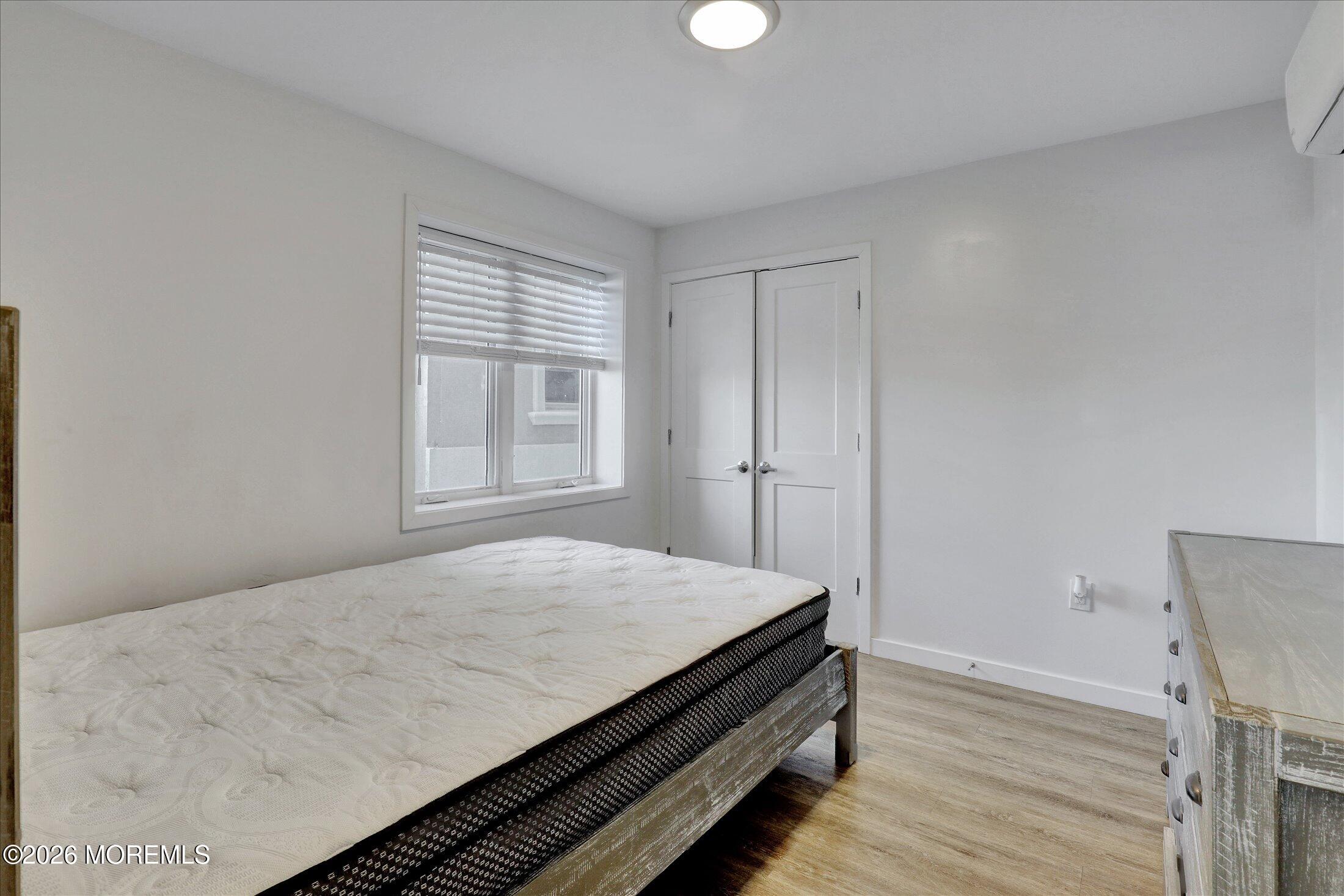 55 Brighton Avenue, Unit 4 Long Branch, NJ 07740 - Photo 25 of 36 a bed sitting in a bedroom next to a window