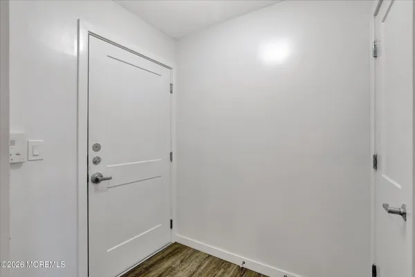 a view of a room with wooden floor