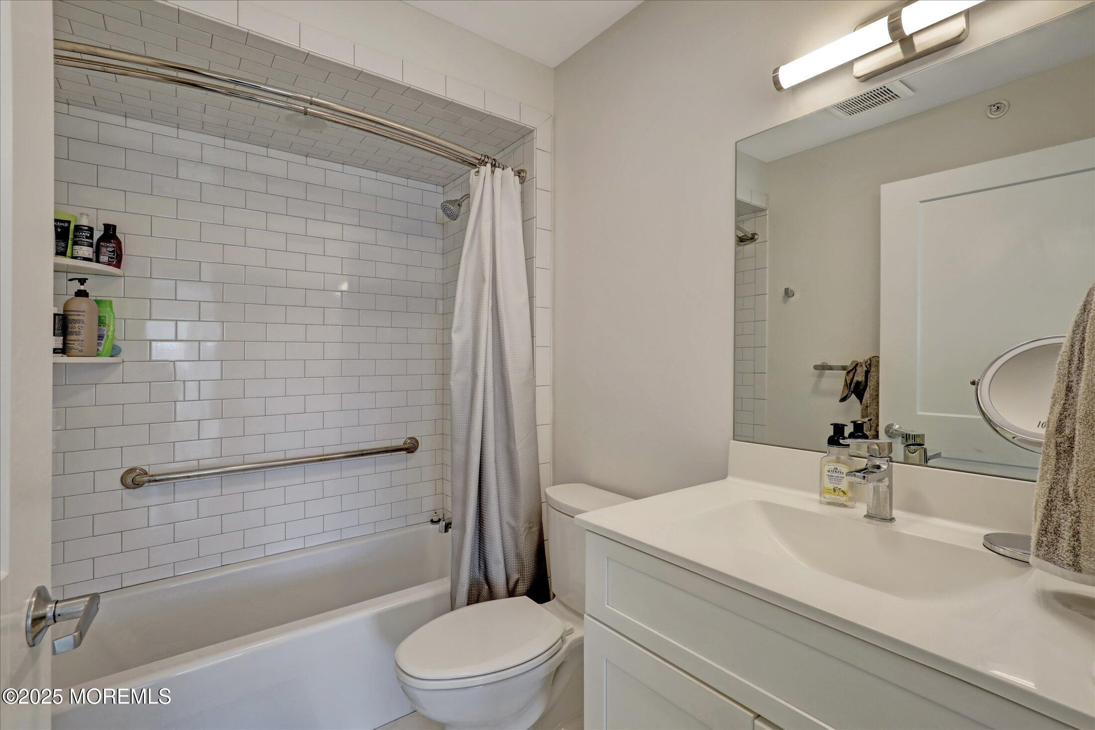 55 Brighton Avenue, Unit 4 Long Branch, NJ 07740 - Photo 10 of 33 a bathroom with a sink a toilet and shower