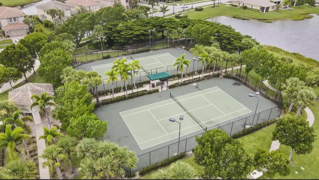 an aerial view of a house with a yard and lake view