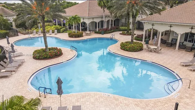 an aerial view of residential house with outdoor space and swimming pool