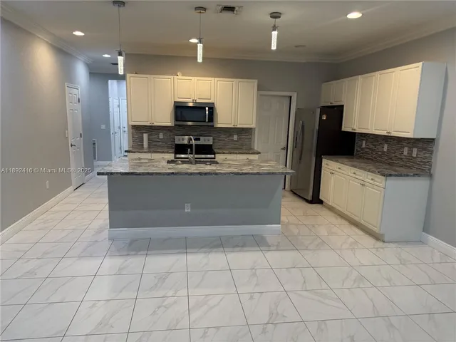 a large kitchen with cabinets