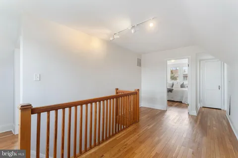 a view of an empty room with a fireplace and a window