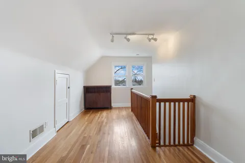 a view of a room with wooden floor