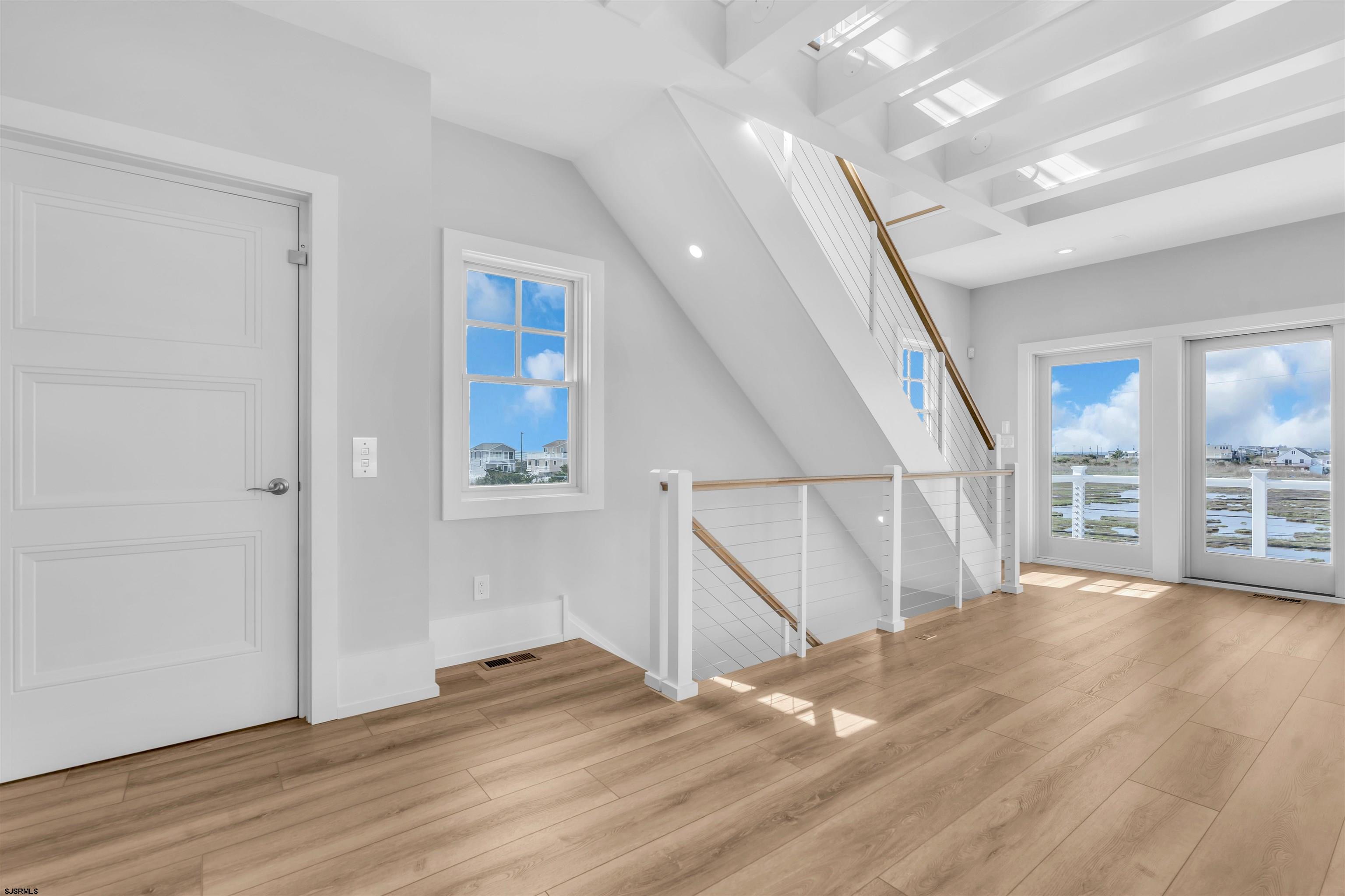 117 Taylor Avenue Strathmere, NJ 08248 - Photo 11 of 70 a view of an empty room with wooden floor and stairs