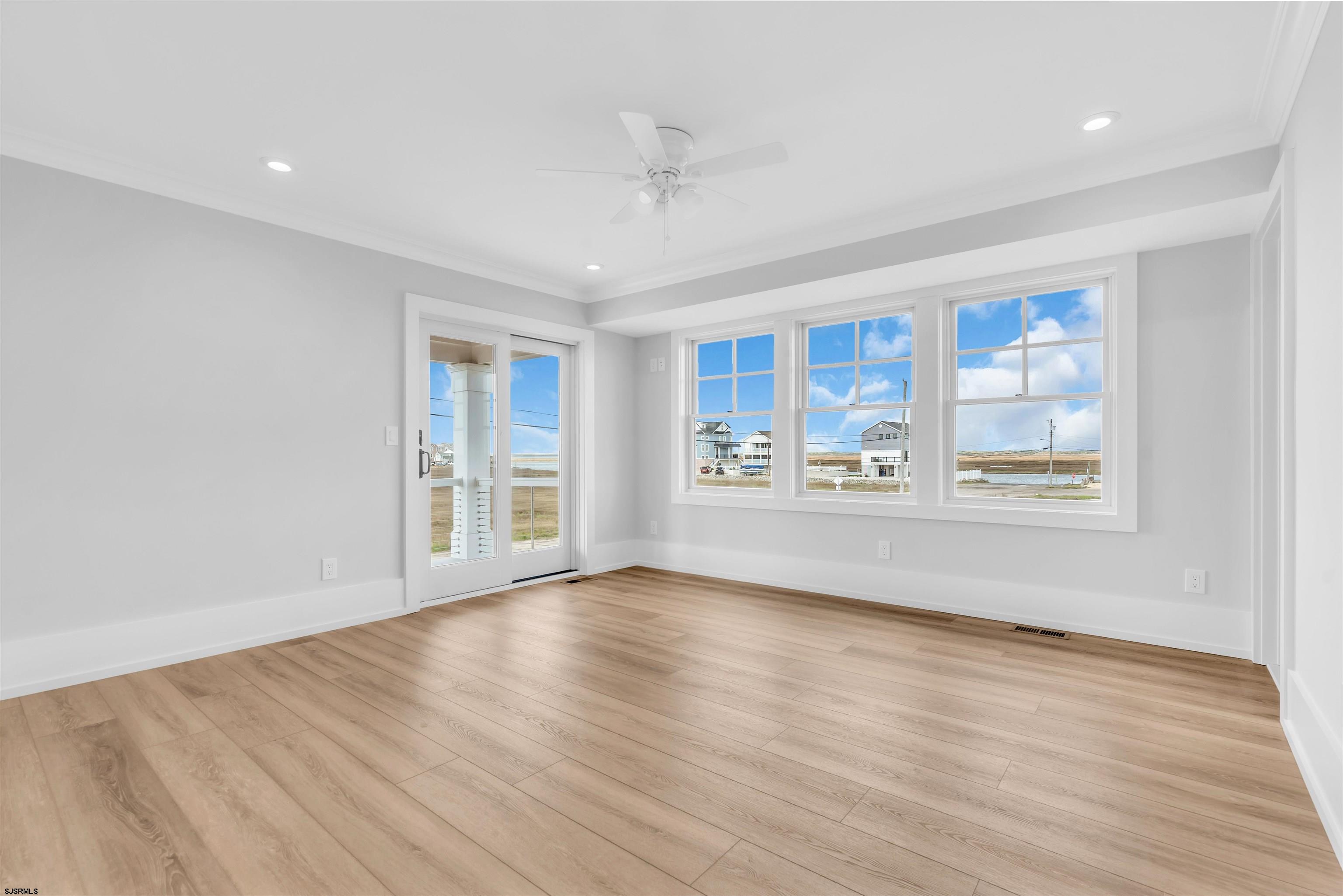 117 Taylor Avenue Strathmere, NJ 08248 - Photo 12 of 70 a view of an empty room with a window and wooden floor