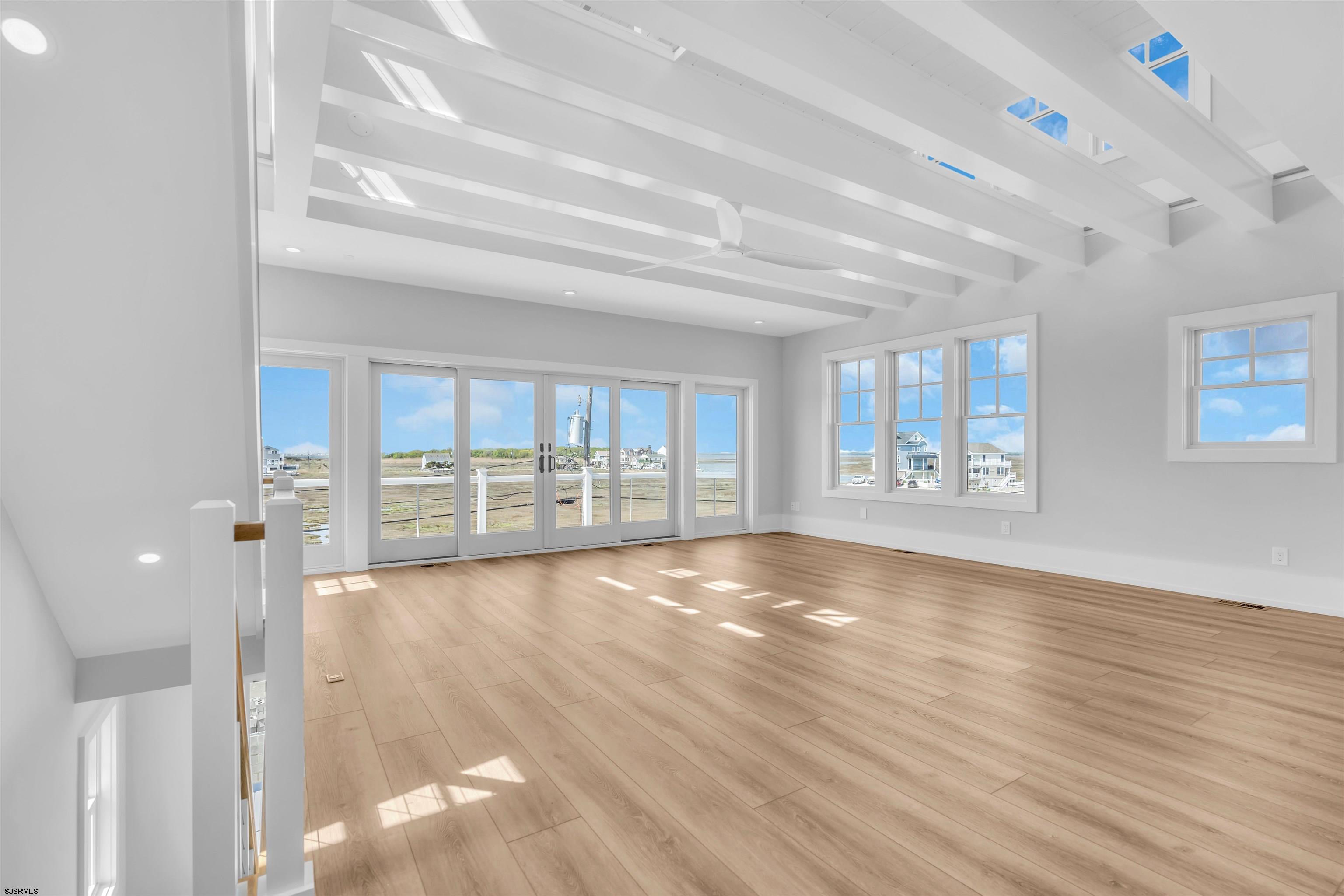 117 Taylor Avenue Strathmere, NJ 08248 - Photo 14 of 70 a view of an empty room with wooden floor and a window