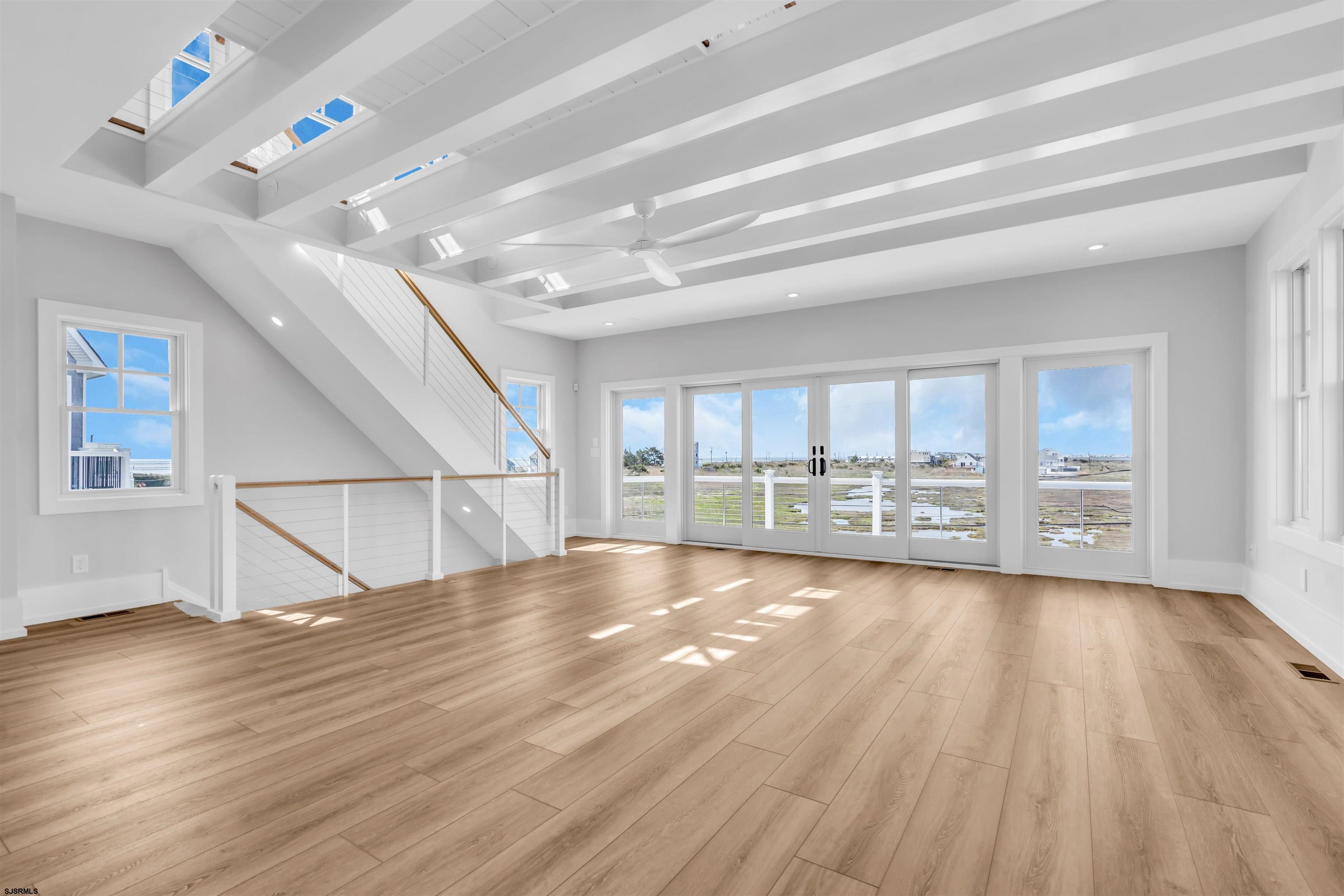 117 Taylor Avenue Strathmere, NJ 08248 - Photo 18 of 70 a view of an empty room with wooden floor and a window