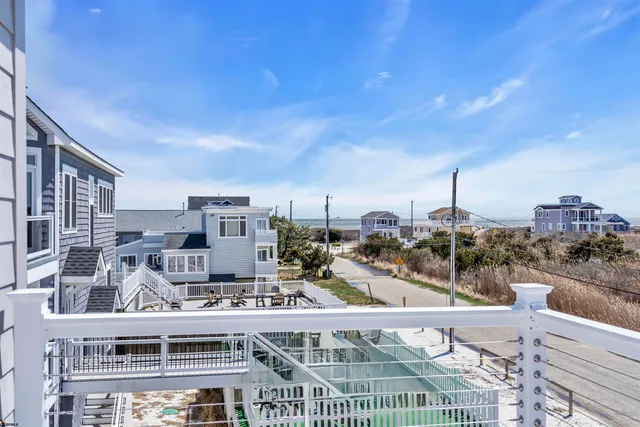a kitchen with kitchen island white cabinets and stainless steel appliances