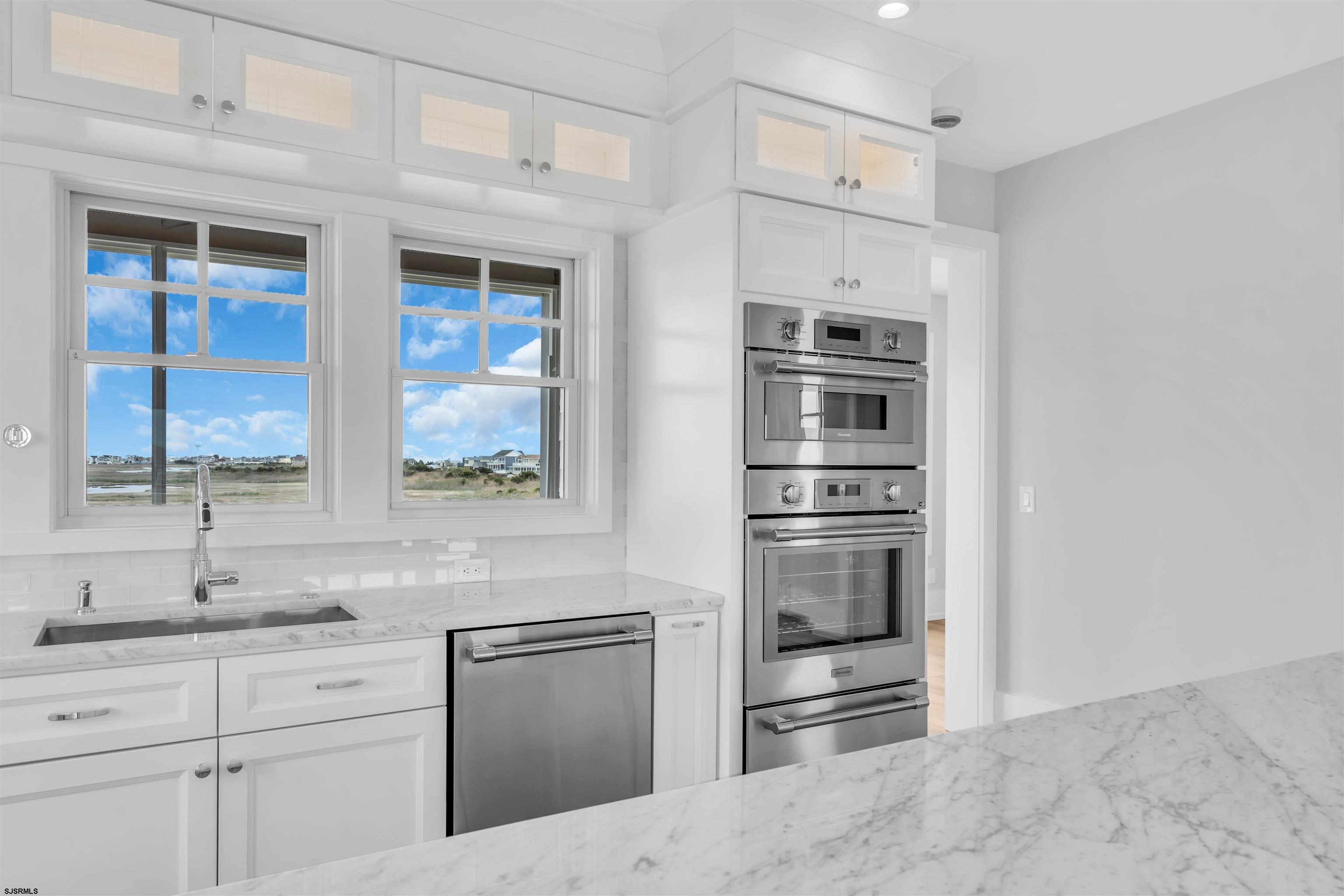 117 Taylor Avenue Strathmere, NJ 08248 - Photo 28 of 70 a kitchen with stainless steel appliances cabinets and a window