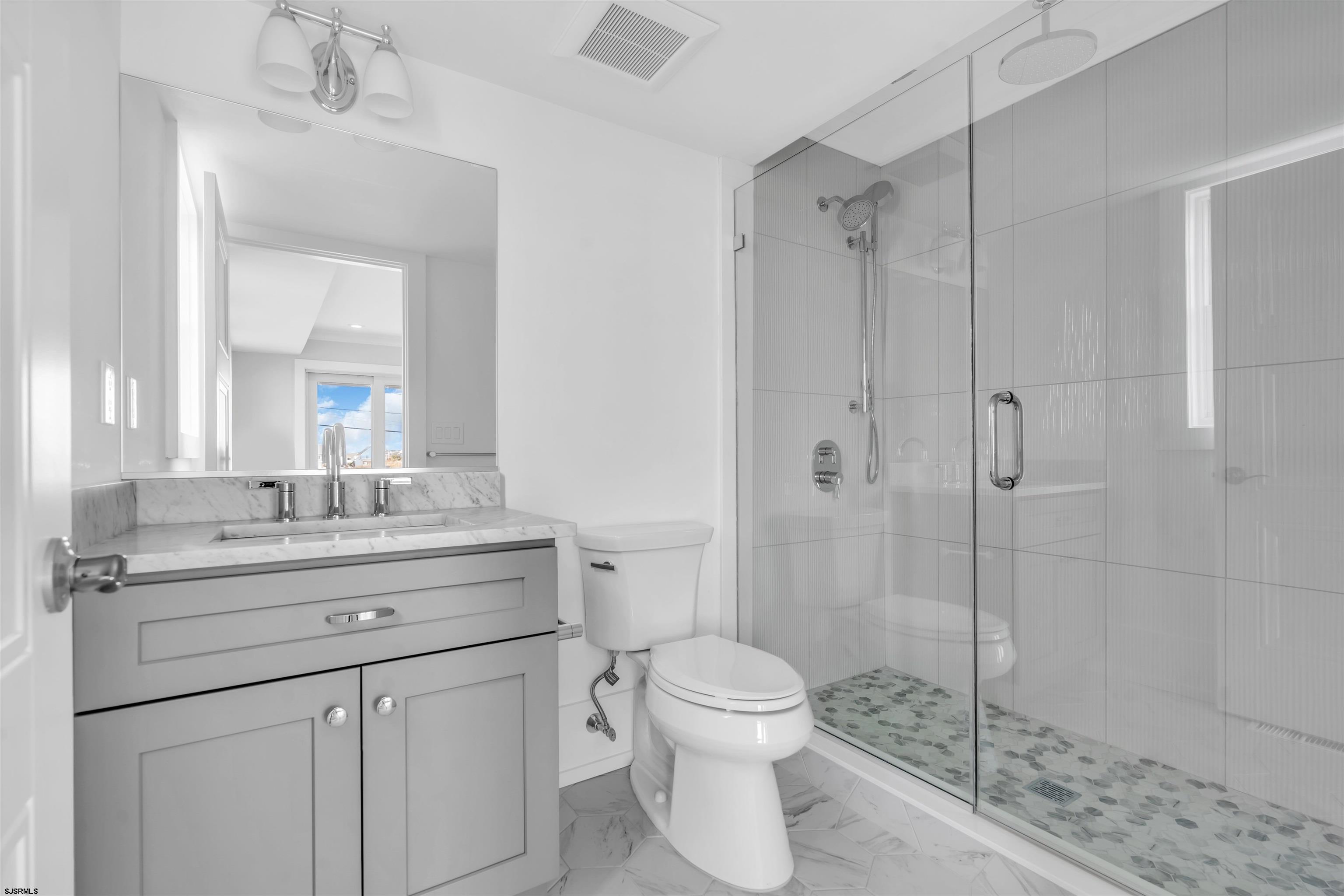 117 Taylor Avenue Strathmere, NJ 08248 - Photo 37 of 70 a bathroom with a shower sink vanity and toilet