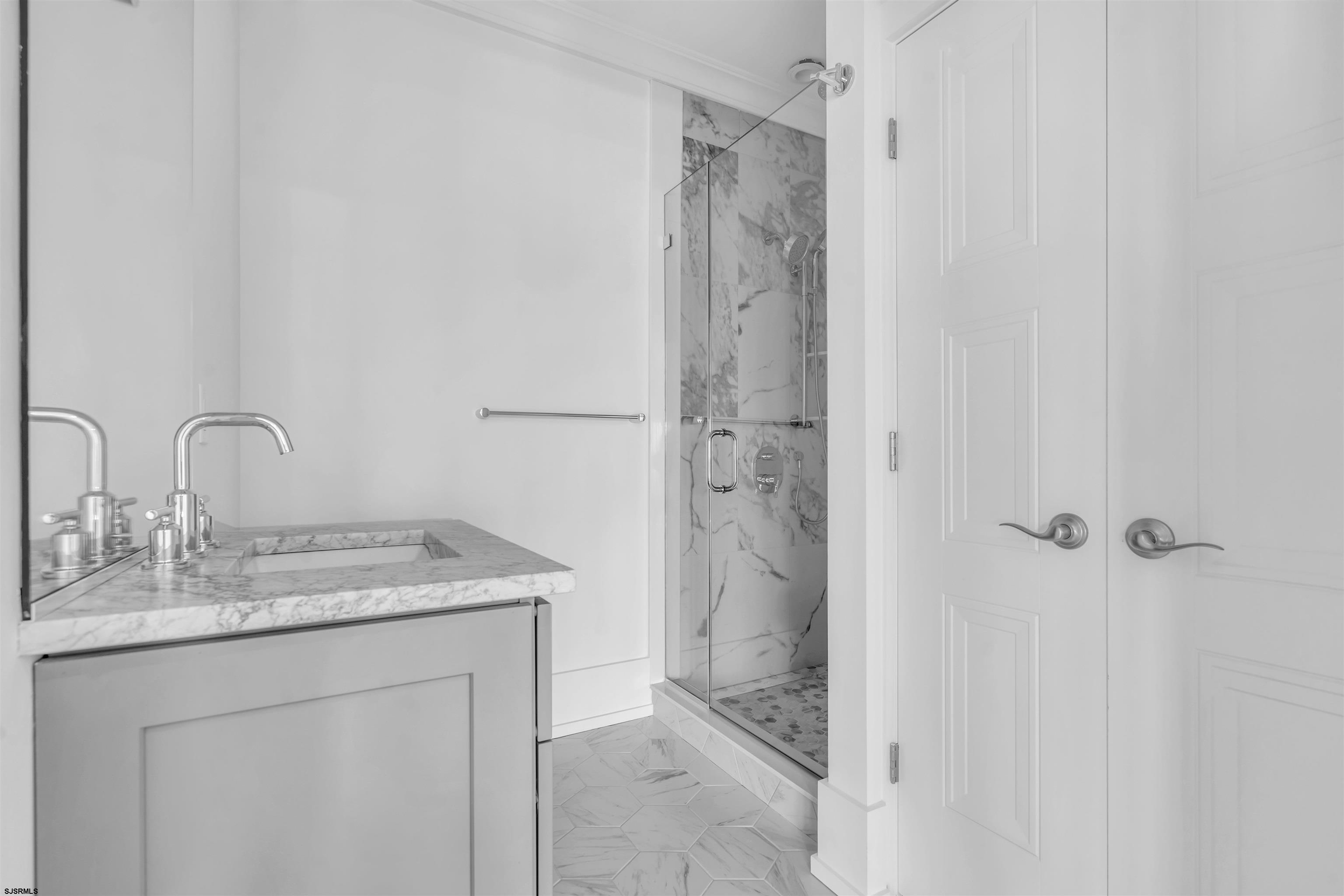 117 Taylor Avenue Strathmere, NJ 08248 - Photo 38 of 70 a bathroom with a granite countertop sink and a mirror