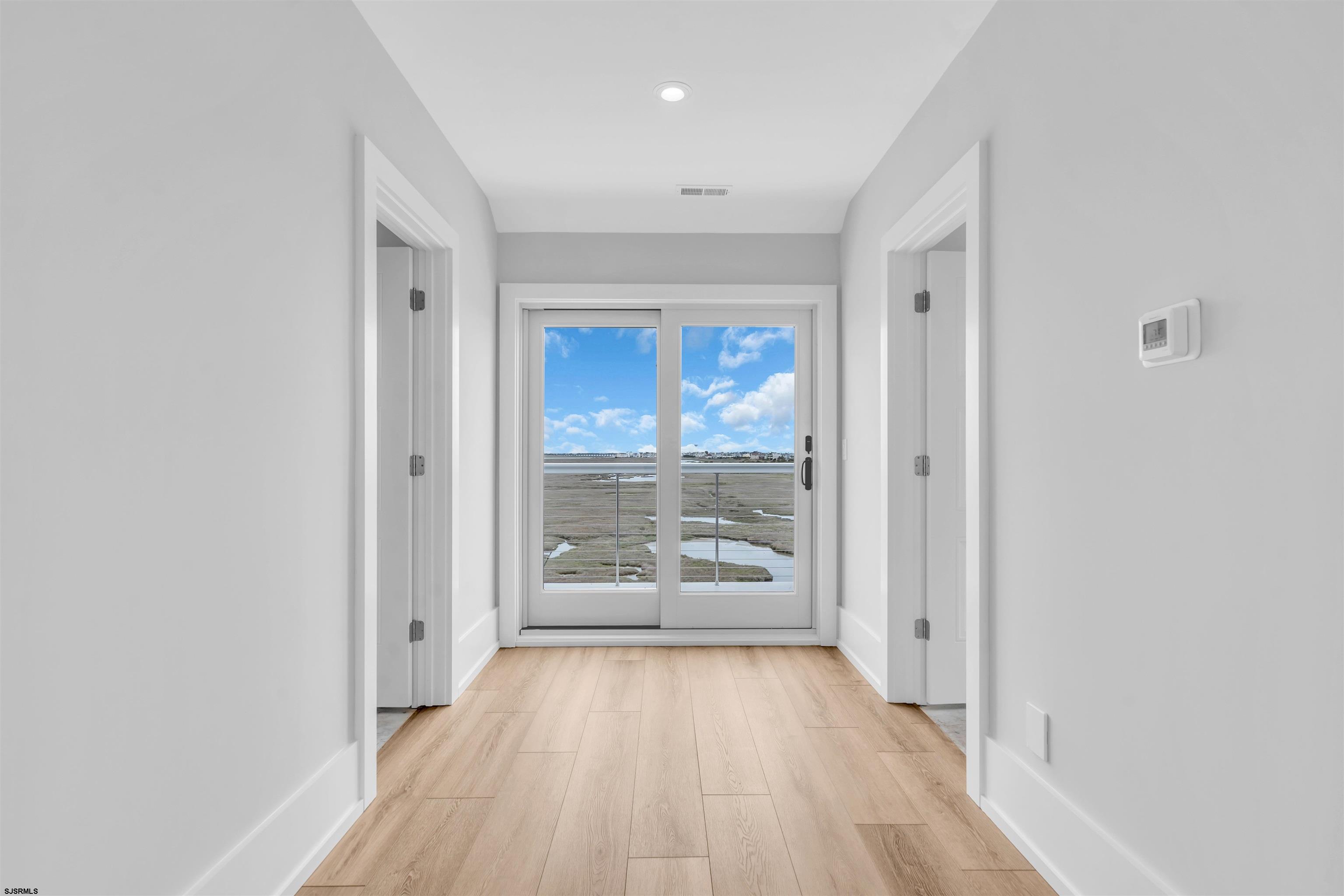 117 Taylor Avenue Strathmere, NJ 08248 - Photo 51 of 70 a view of a hallway with wooden floor and a living room