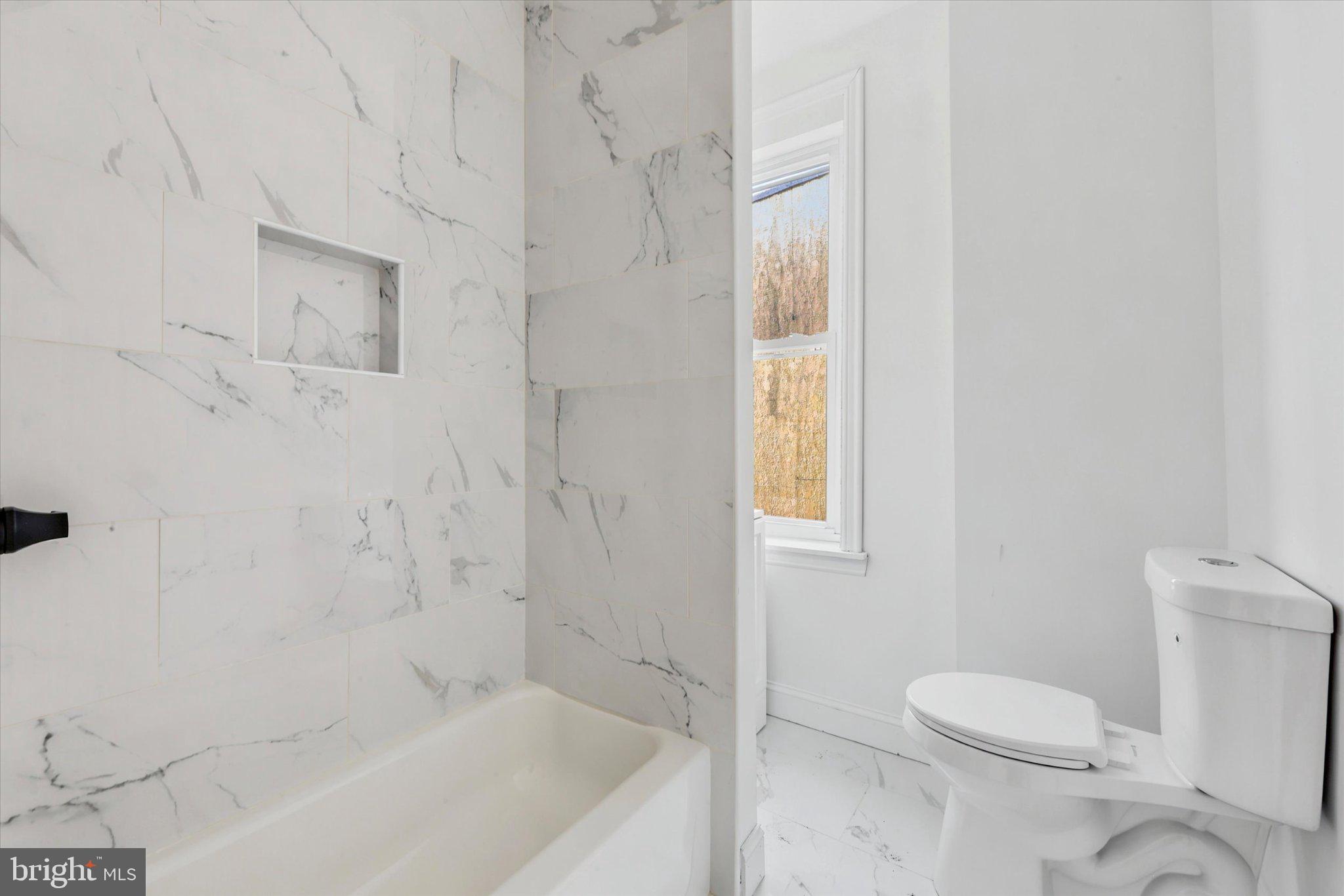2046 South Norwood Street, Unit 2 Philadelphia, PA 19145 - Photo 13 of 17 Elegant marble-clad bathroom retreat.