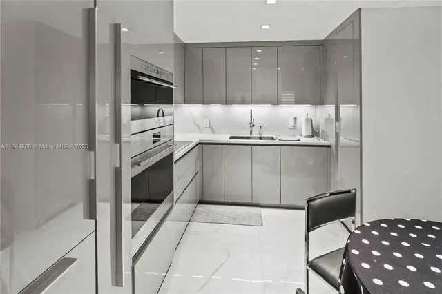 a kitchen with stainless steel appliances granite countertop a stove a sink and a refrigerator