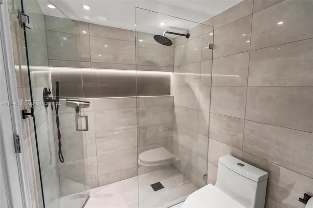 a bathroom with a toilet and shower